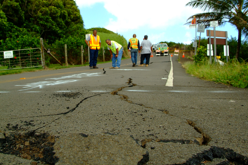 Kapaau, HI, October 25, 2006- DOT crews observe a  long crack that splits the pavement at Pololu Lookout after two earthquakes struck the Big Island of Hawaii. Adam DuBrowa/FEMA.